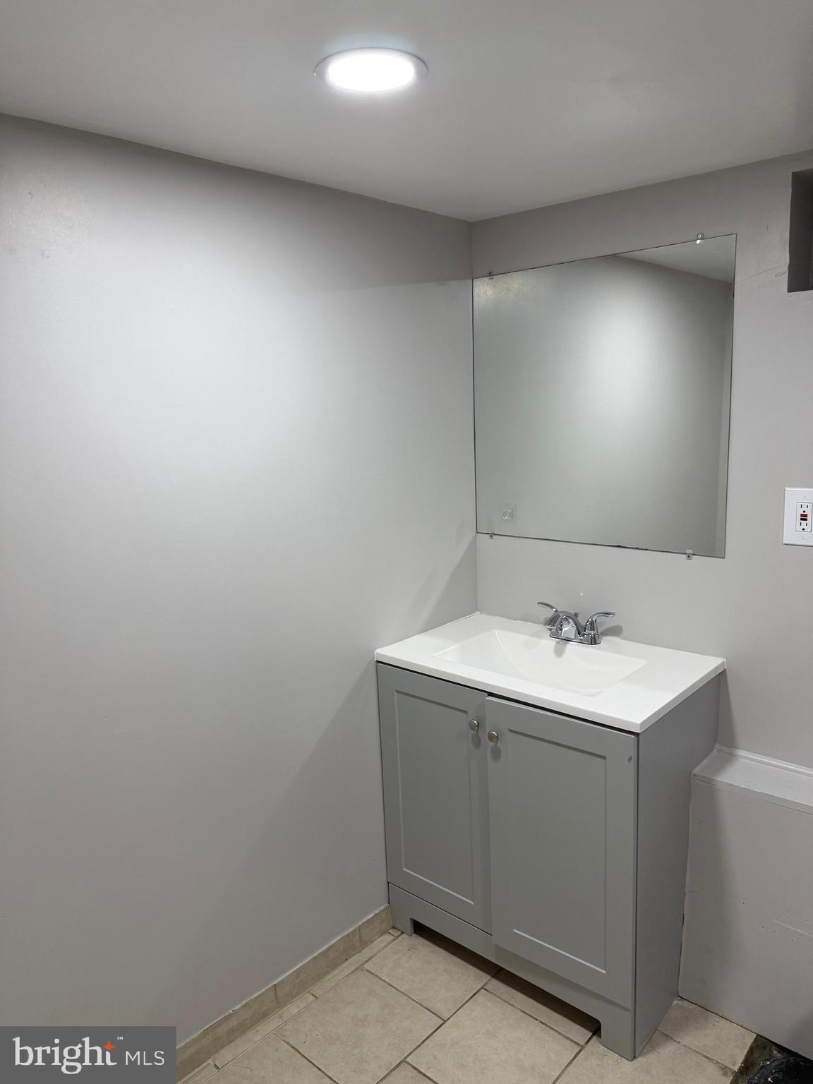 1353 Cambria Street Baltimore, MD 21225 - Photo 17 of 23 a bathroom with a sink a vanity and mirror