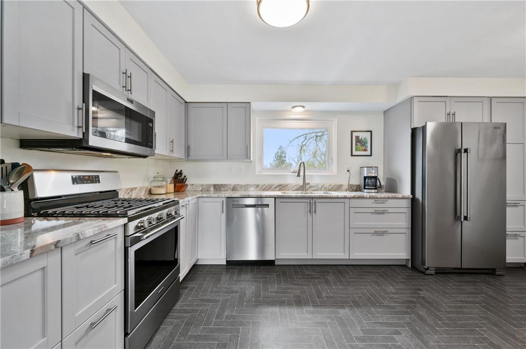 419 Amherst Avenue Coraopolis, PA 15108 - Photo 11 of 29 a kitchen with white cabinets and stainless steel appliances