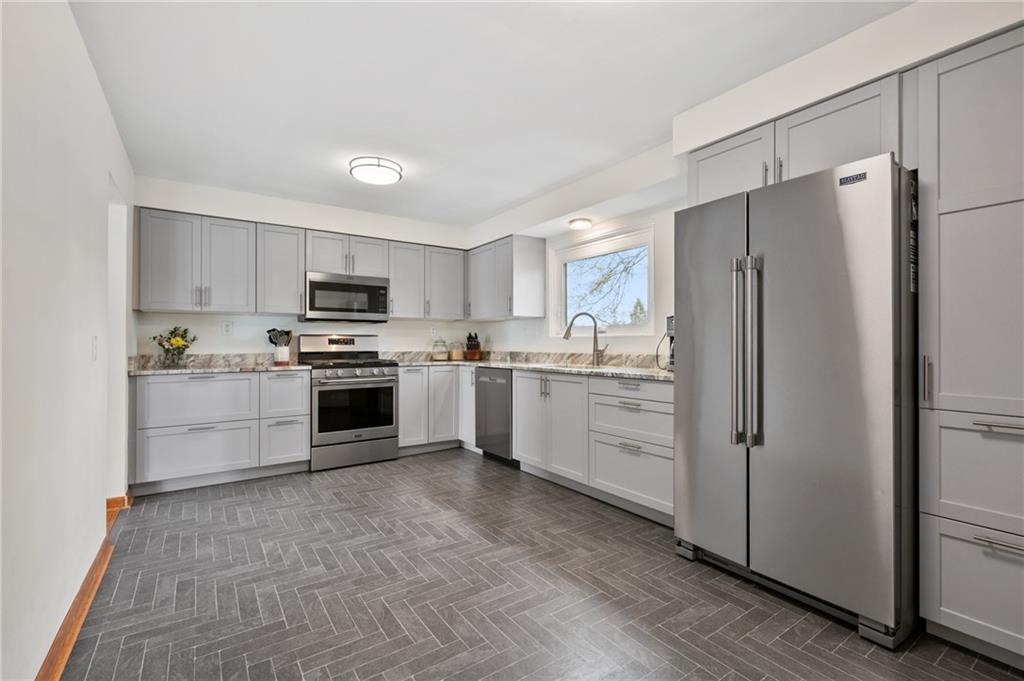 419 Amherst Avenue Coraopolis, PA 15108 - Photo 12 of 29 a kitchen with white cabinets and stainless steel appliances