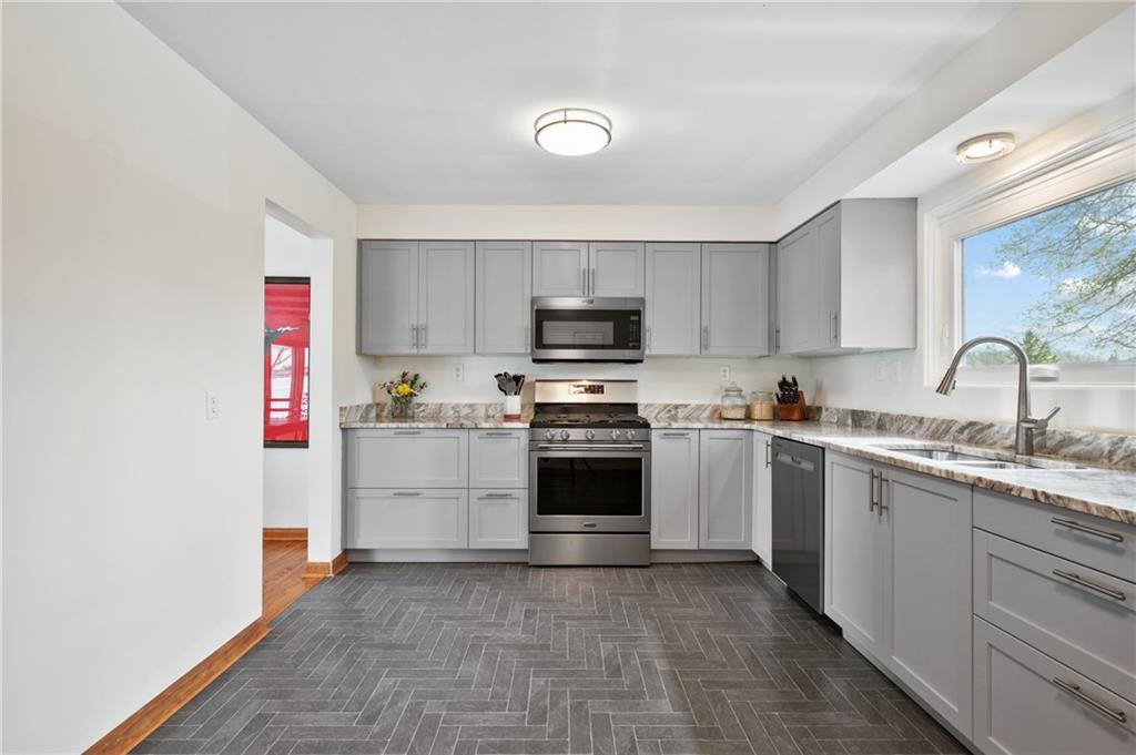 419 Amherst Avenue Coraopolis, PA 15108 - Photo 13 of 29 a kitchen with granite countertop a sink stainless steel appliances and cabinets