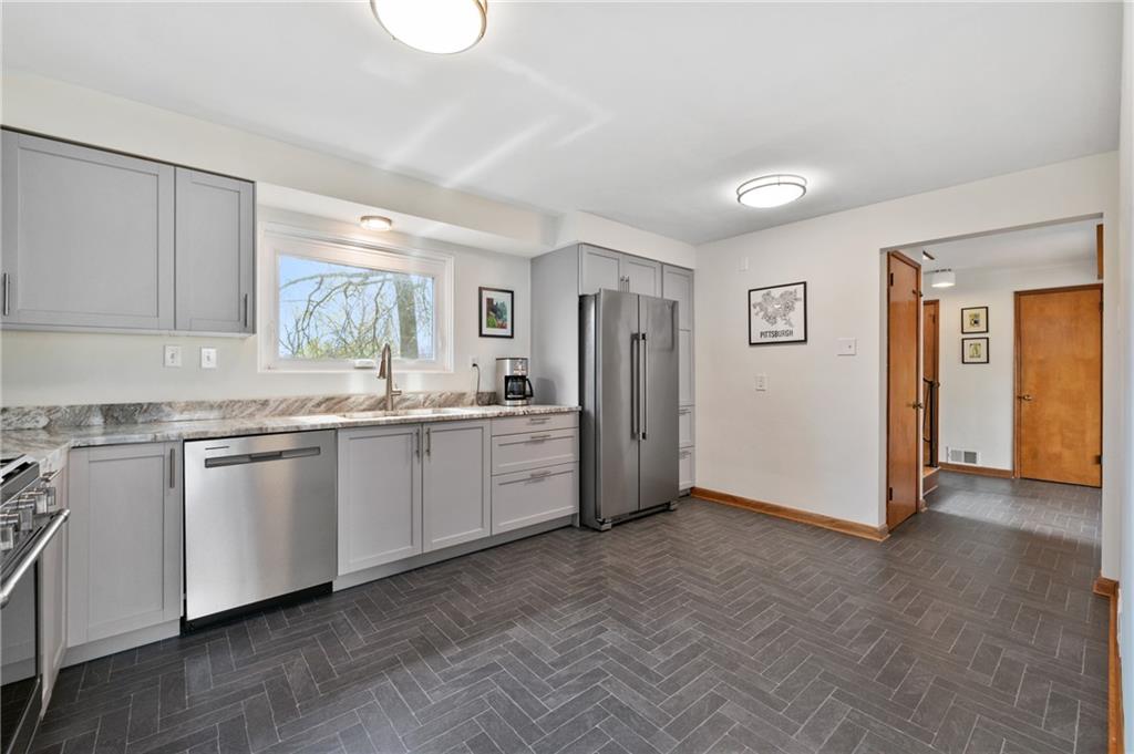 419 Amherst Avenue Coraopolis, PA 15108 - Photo 14 of 29 a kitchen with granite countertop a refrigerator and a sink