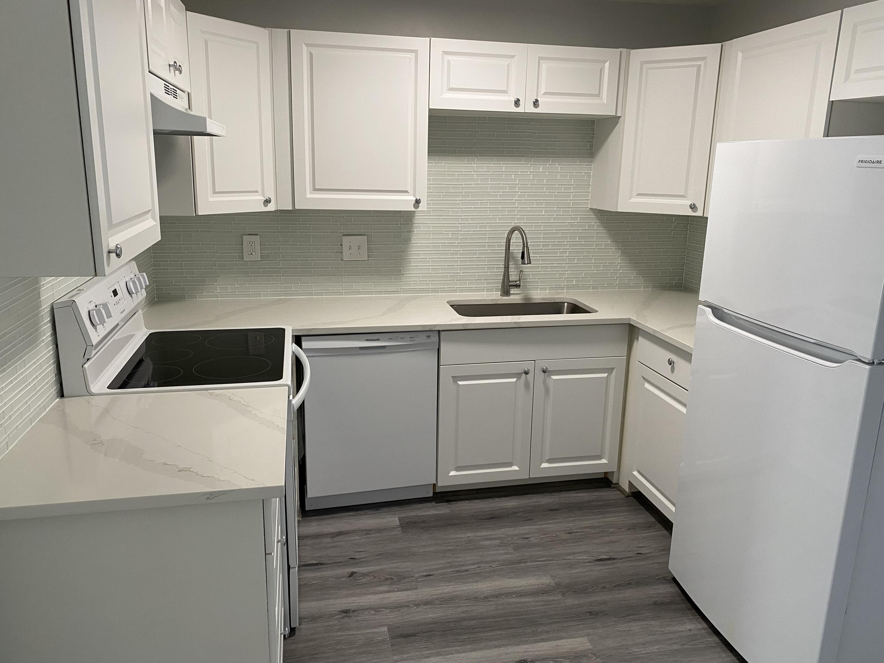 103 Southeast Norfolk Boulevard Stuart, FL 34997 - Photo 12 of 34 a kitchen with a sink a stove and cabinets