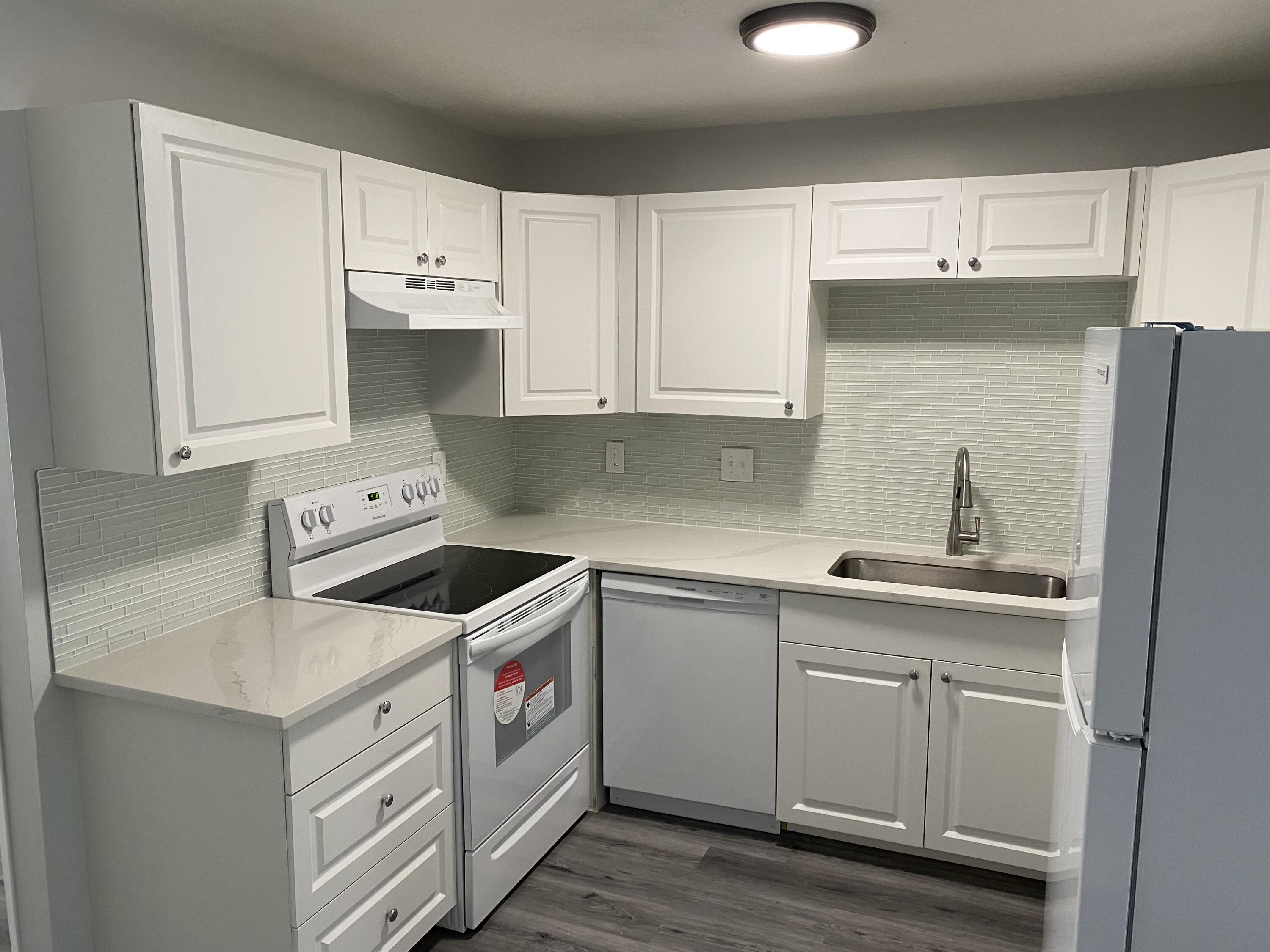 103 Southeast Norfolk Boulevard Stuart, FL 34997 - Photo 14 of 34 a kitchen with cabinets appliances and a sink