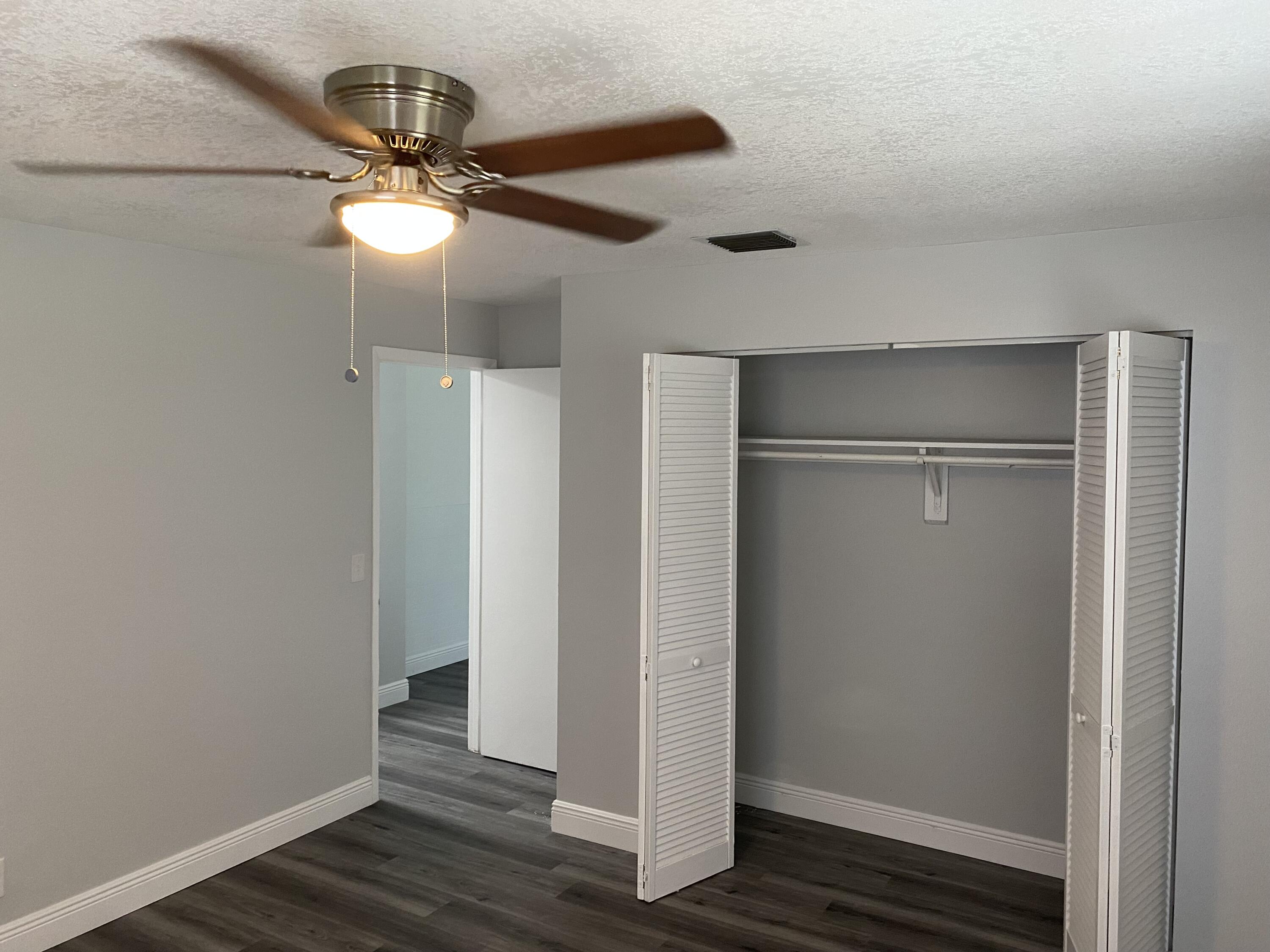 103 Southeast Norfolk Boulevard Stuart, FL 34997 - Photo 18 of 34 a view of an empty room with wooden floor