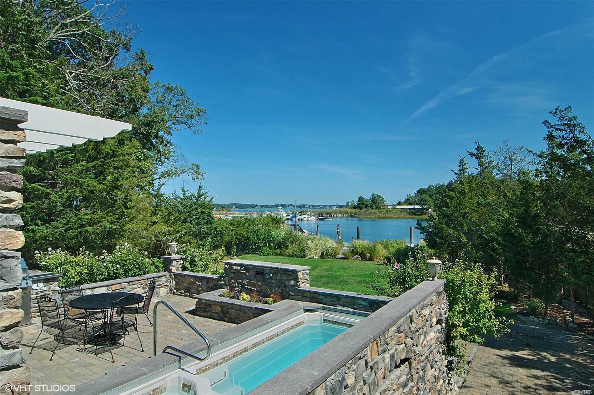 a view of a white house with a yard and furniture