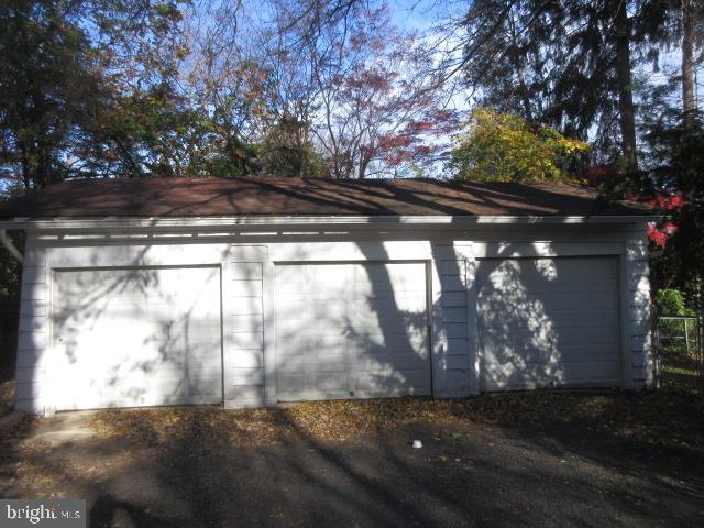 407 West Waverly Road Glenside, PA 19038 - Photo 3 of 23 a backyard of a house with large trees and plants
