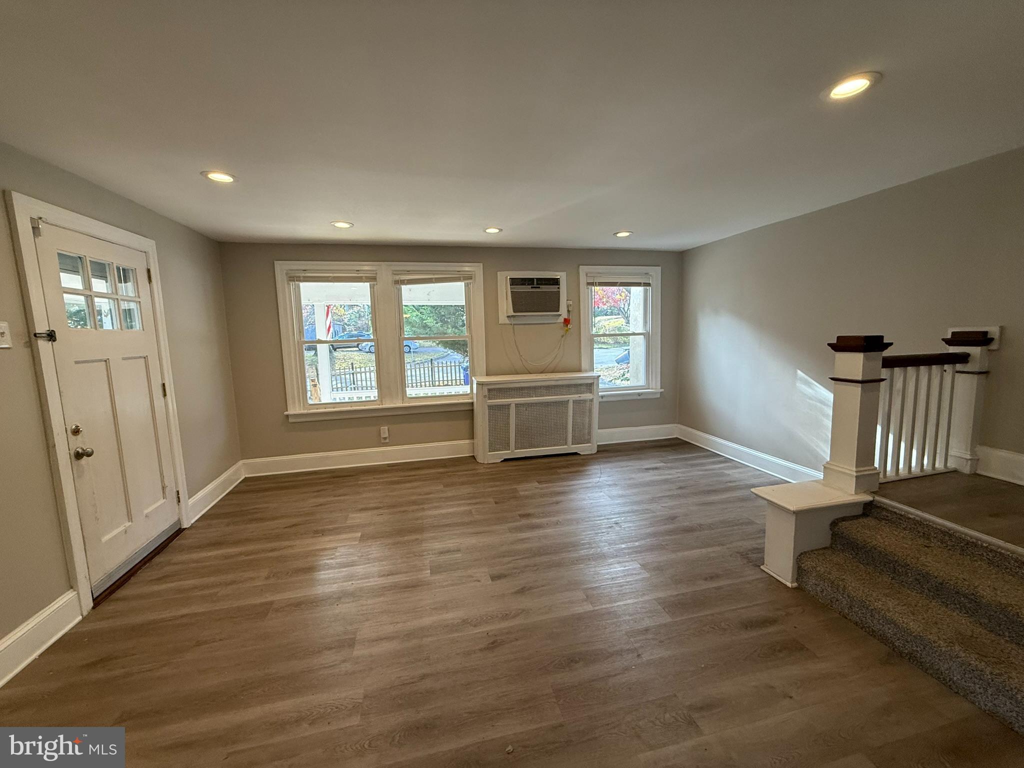 407 West Waverly Road Glenside, PA 19038 - Photo 4 of 23 an empty room with wooden floor and windows