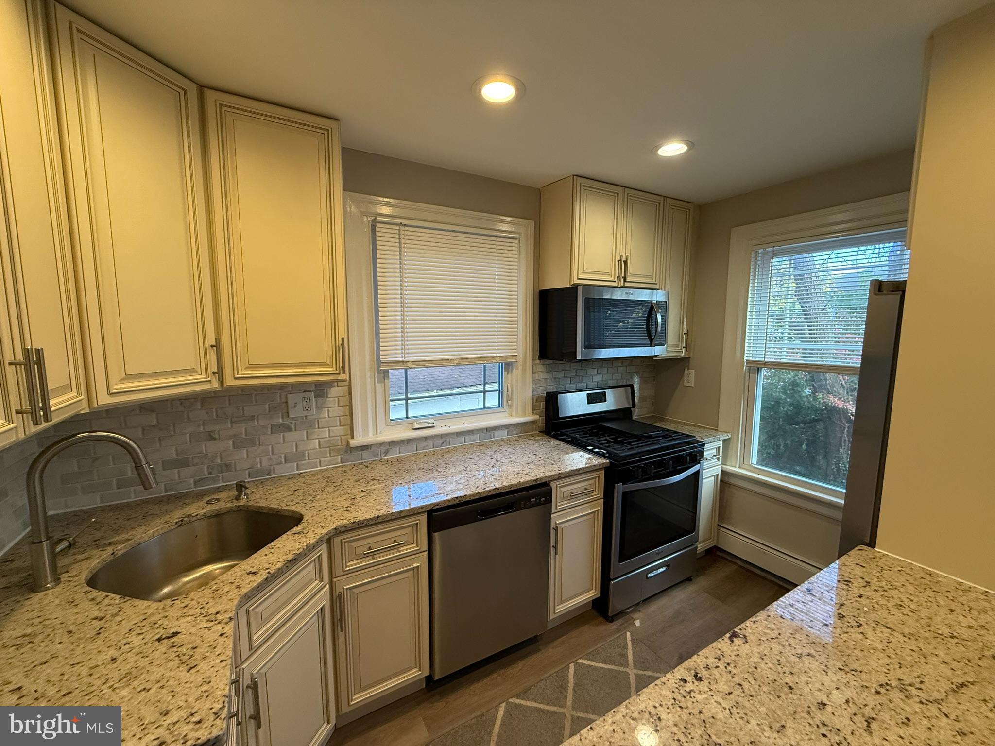 407 West Waverly Road Glenside, PA 19038 - Photo 6 of 23 a kitchen with stainless steel appliances granite countertop a sink stove and refrigerator
