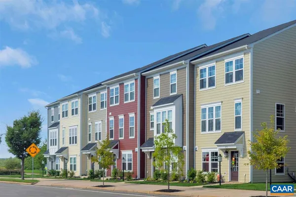 a front view of residential houses with yard