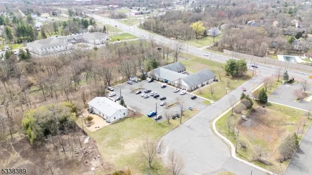 a view of a terrace with dining table and chairs under an umbrella
