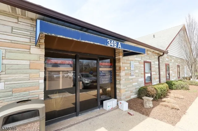 a view of house with wooden fence and a yard