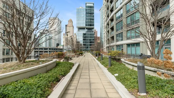 a view of buildings with yard and green space