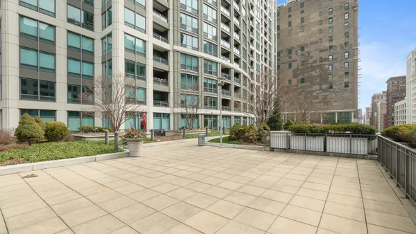 a view of a building with a bench and a pathway