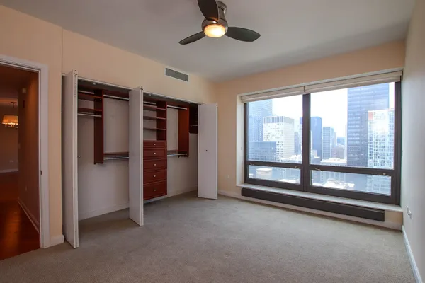 a view of an empty room with a fireplace and a window