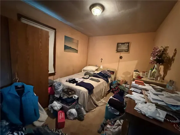 a bedroom with bed and a closet