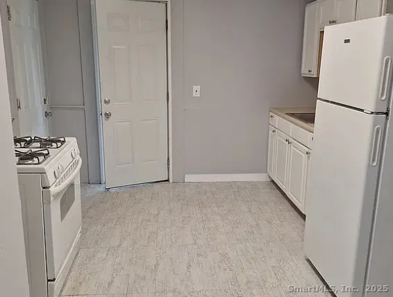 a view of a kitchen with a refrigerator