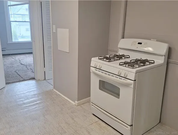 a white stove top oven sitting inside of a house