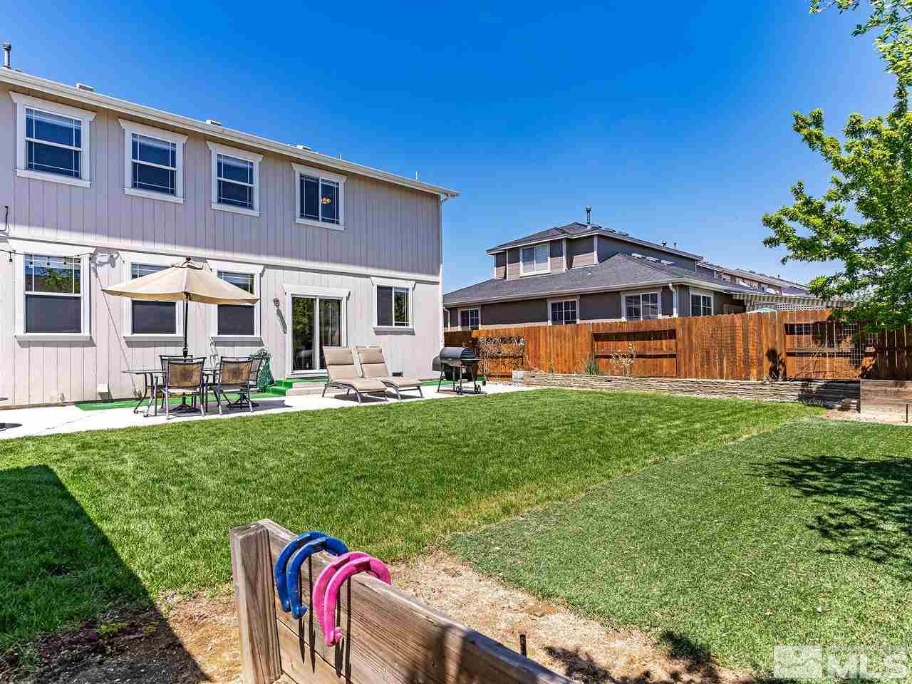 8976 Wynne Street Reno, NV 89506 - Photo 12 of 24 a front view of a house with a yard table and chairs