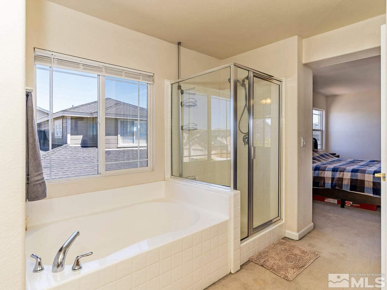 8976 Wynne Street Reno, NV 89506 - Photo 20 of 24 a spacious bathroom with a bathtub and a shower