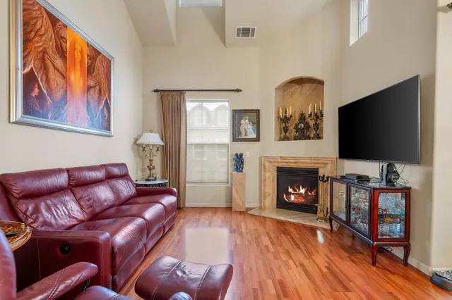 a living room with furniture fireplace and flat screen tv