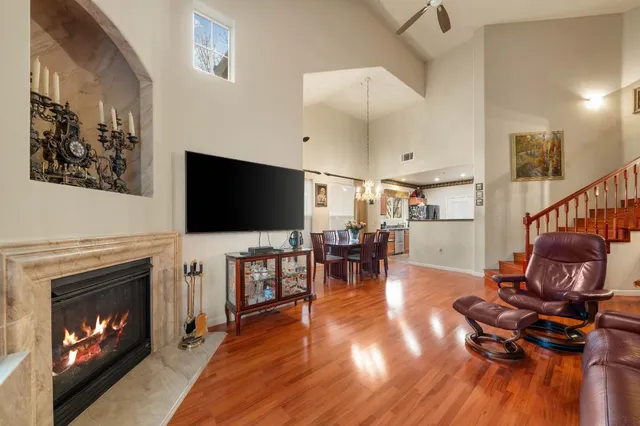 a living room with furniture fireplace and flat screen tv