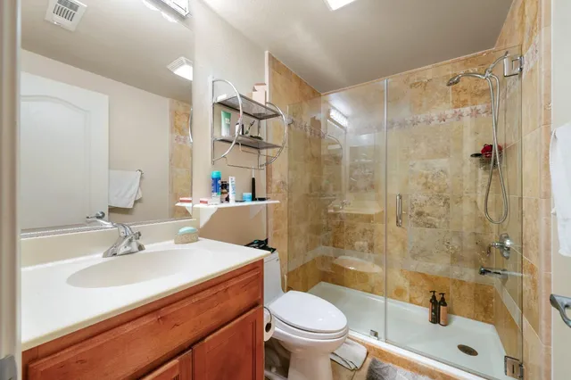 a bathroom with a sink toilet and shower