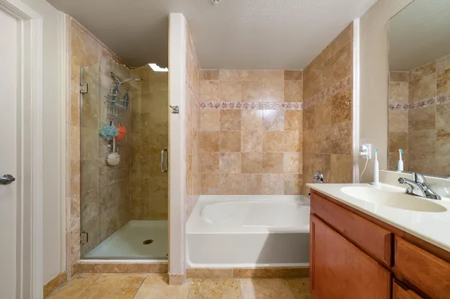 a bathroom with a shower and a sink a mirror