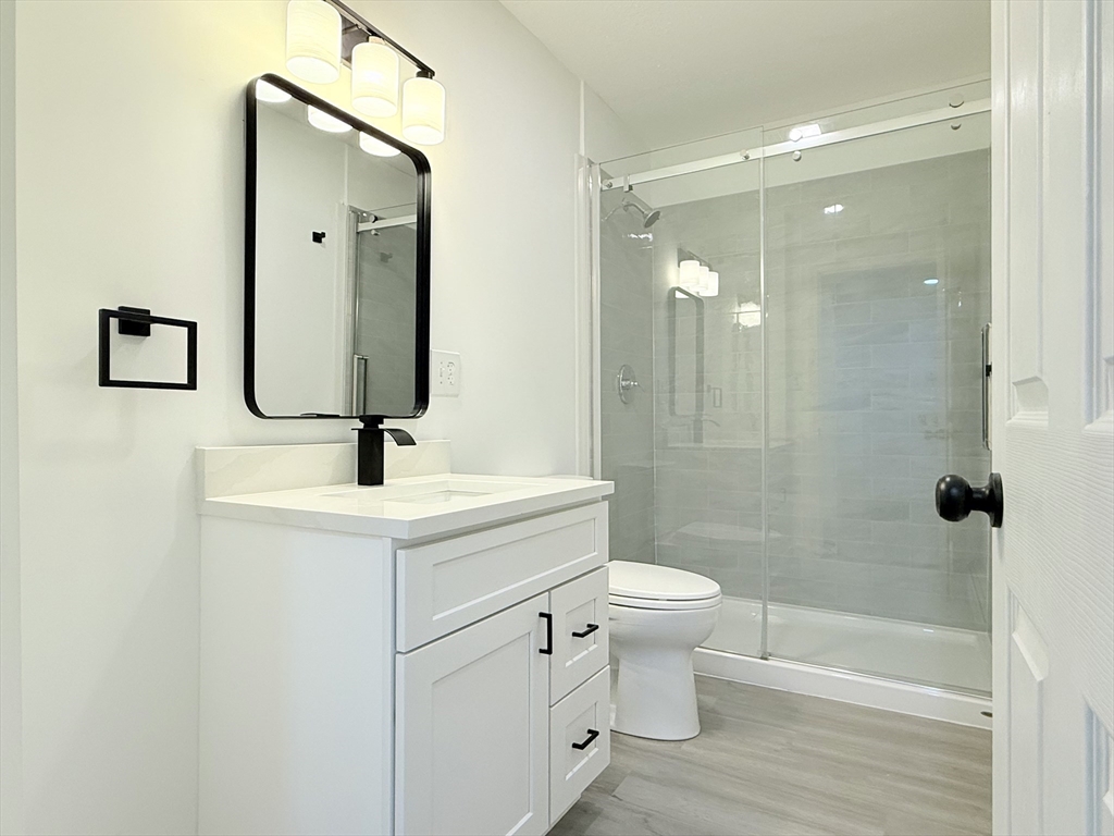 23 Bellevue Street, Unit 1 Worcester, MA 01609 - Photo 12 of 22 a bathroom with a sink a toilet and shower