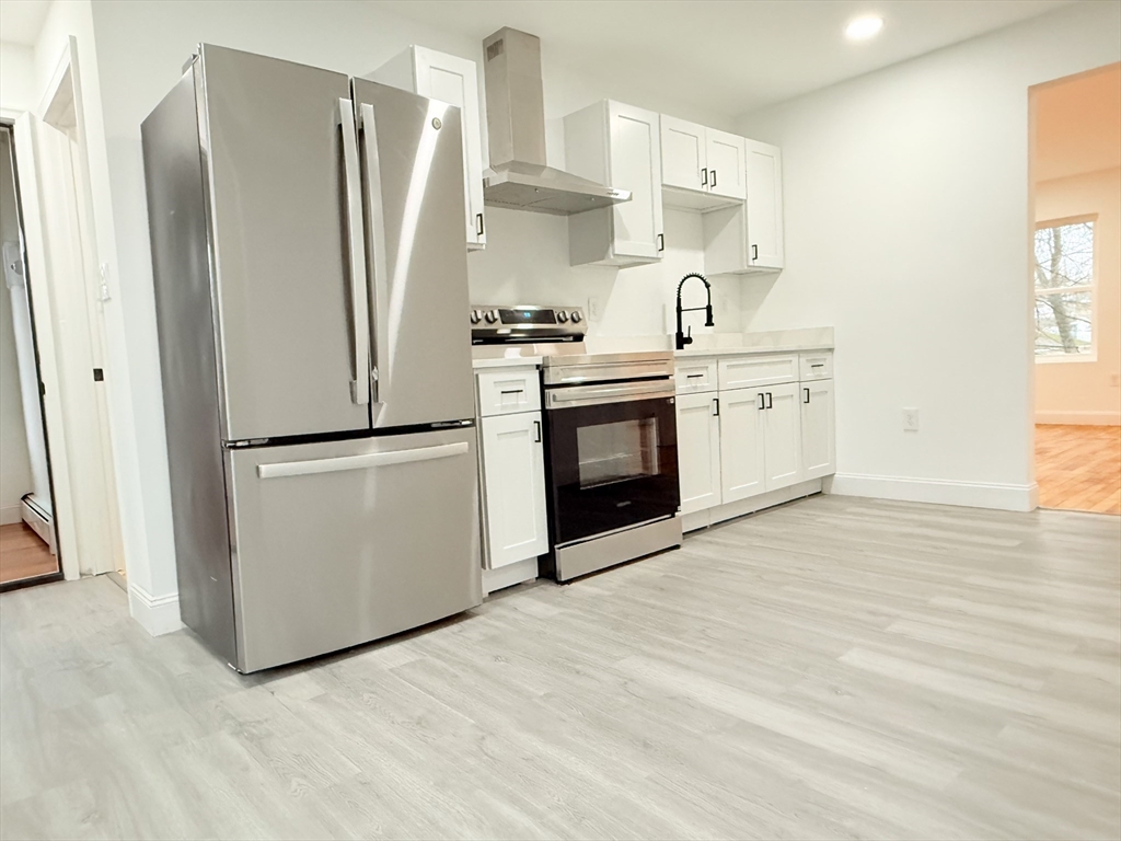 23 Bellevue Street, Unit 1 Worcester, MA 01609 - Photo 9 of 22 a kitchen with stainless steel appliances a refrigerator sink and cabinets
