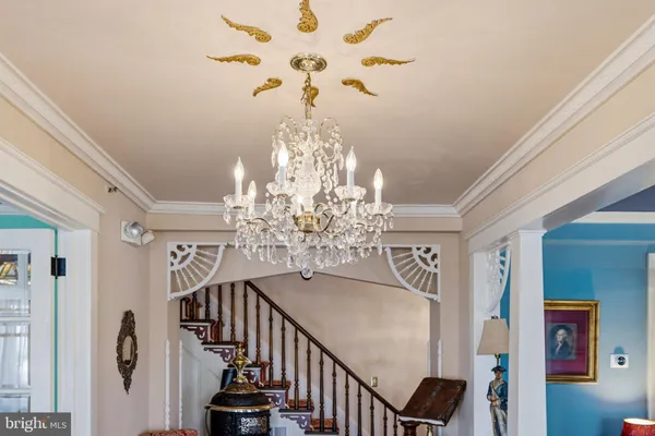 a living room with furniture and a chandelier