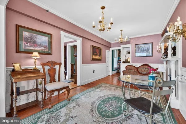 a living room with furniture a fireplace and a painting on the wall