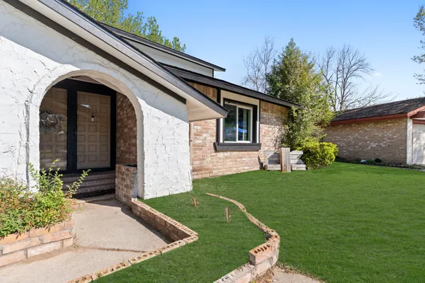 a front view of a house with a garden