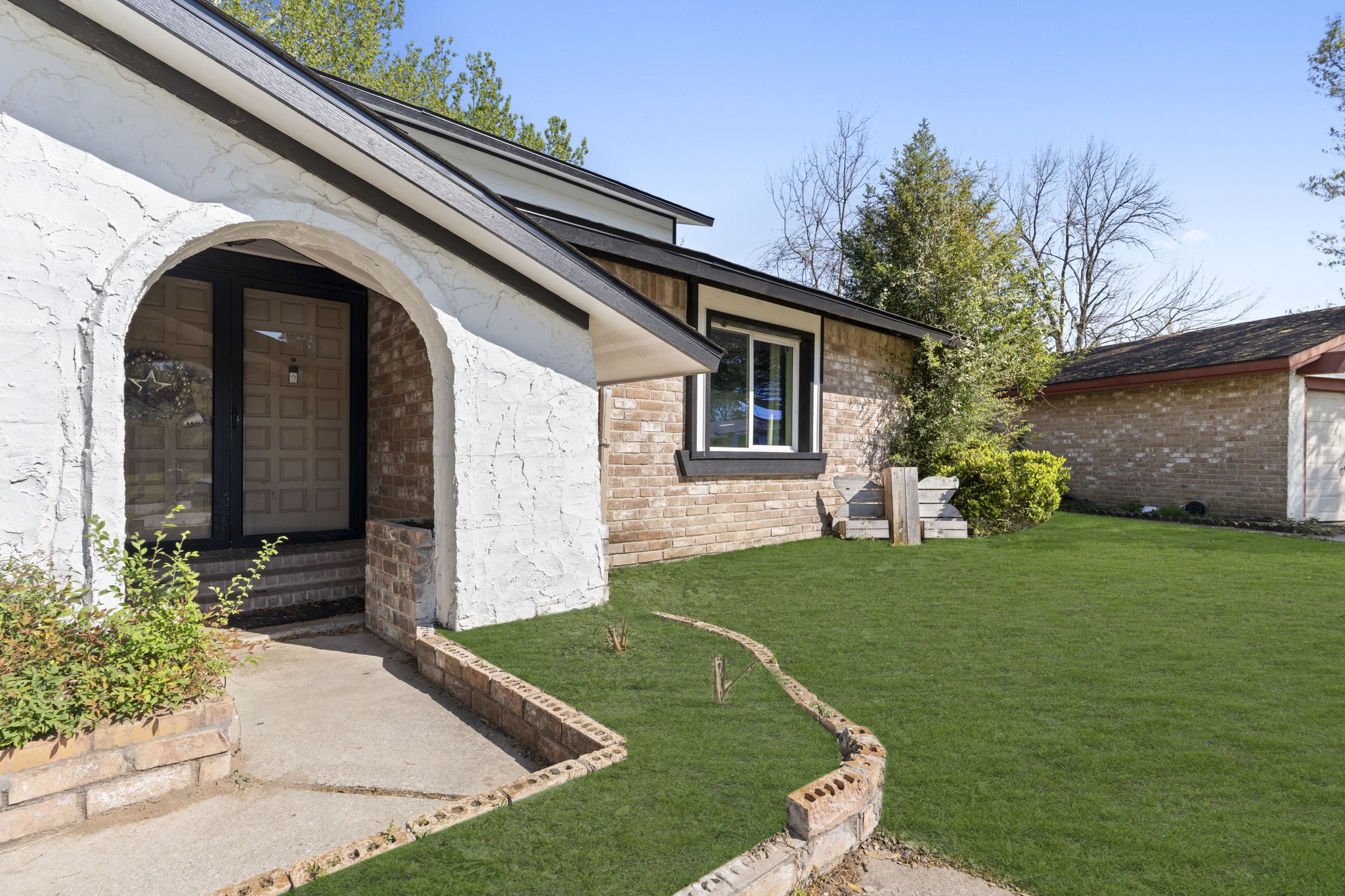 a front view of a house with a garden