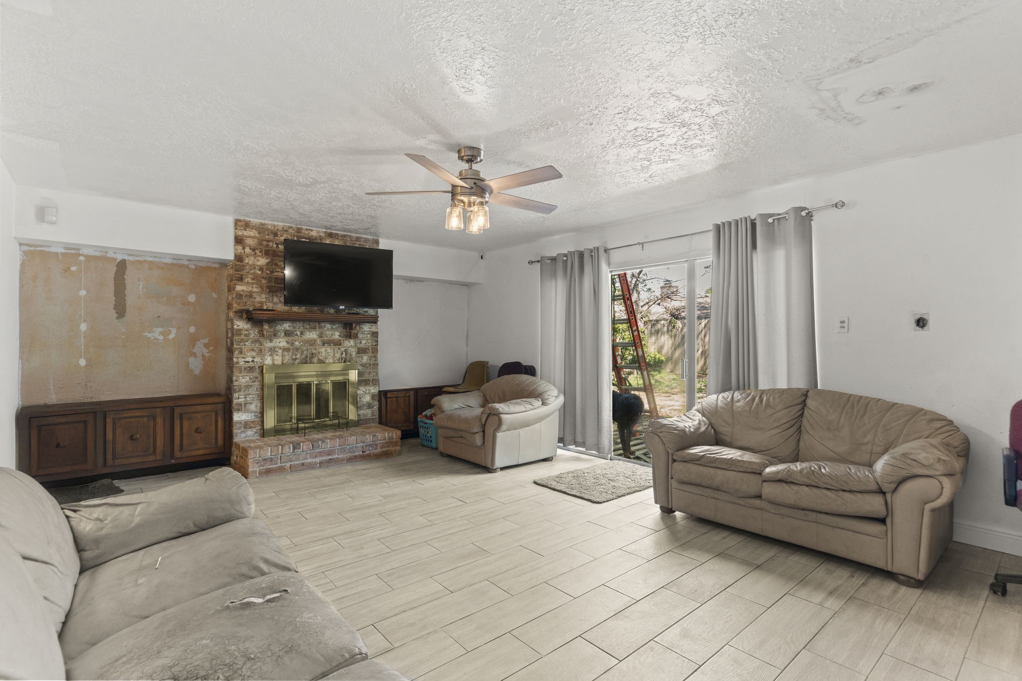 8506 Rivercross Road Houston, TX 77064 - Photo 13 of 32 a living room with furniture and a flat screen tv