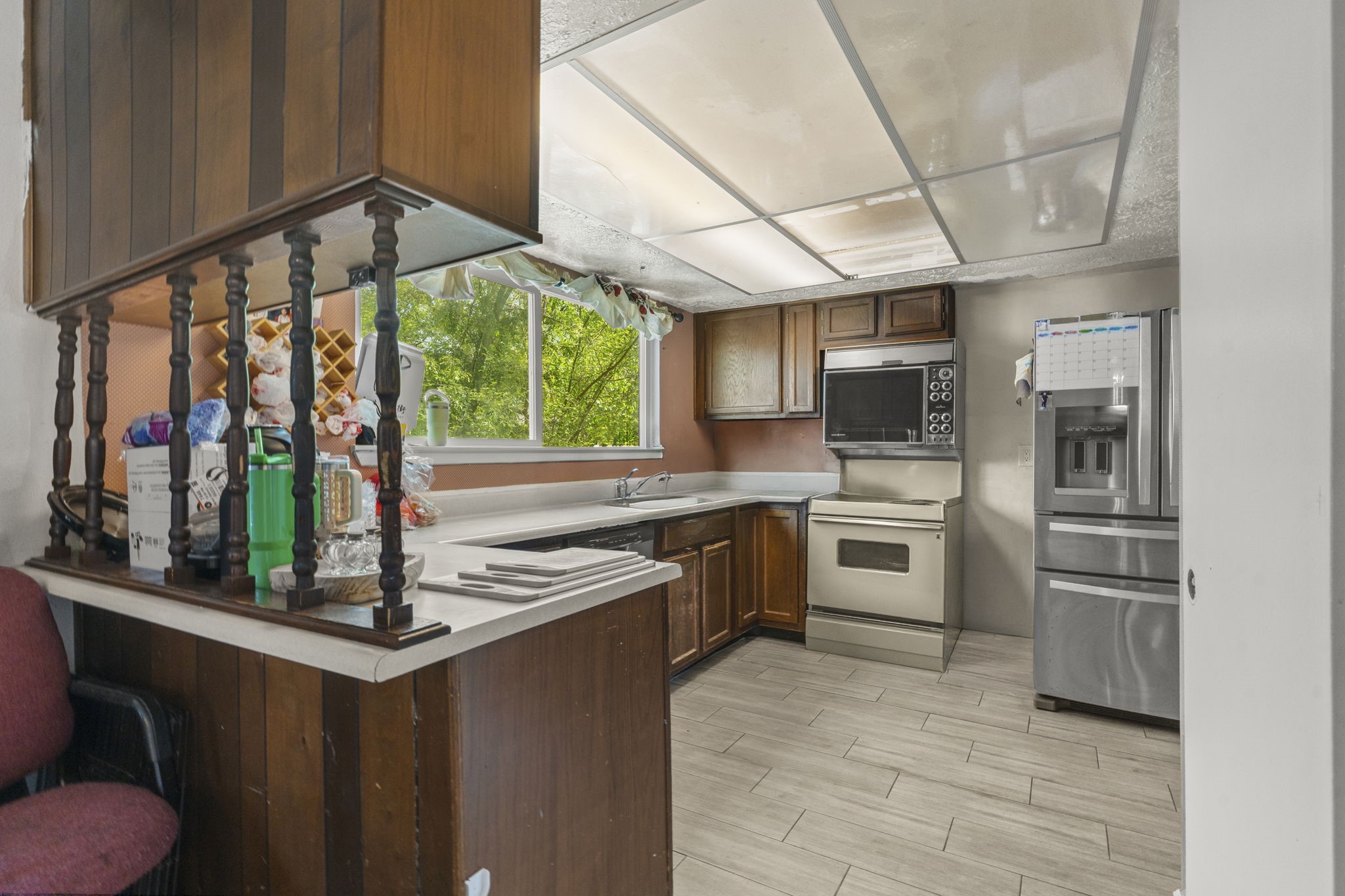 8506 Rivercross Road Houston, TX 77064 - Photo 20 of 32 a kitchen with stainless steel appliances kitchen island granite countertop a refrigerator and a stove top oven