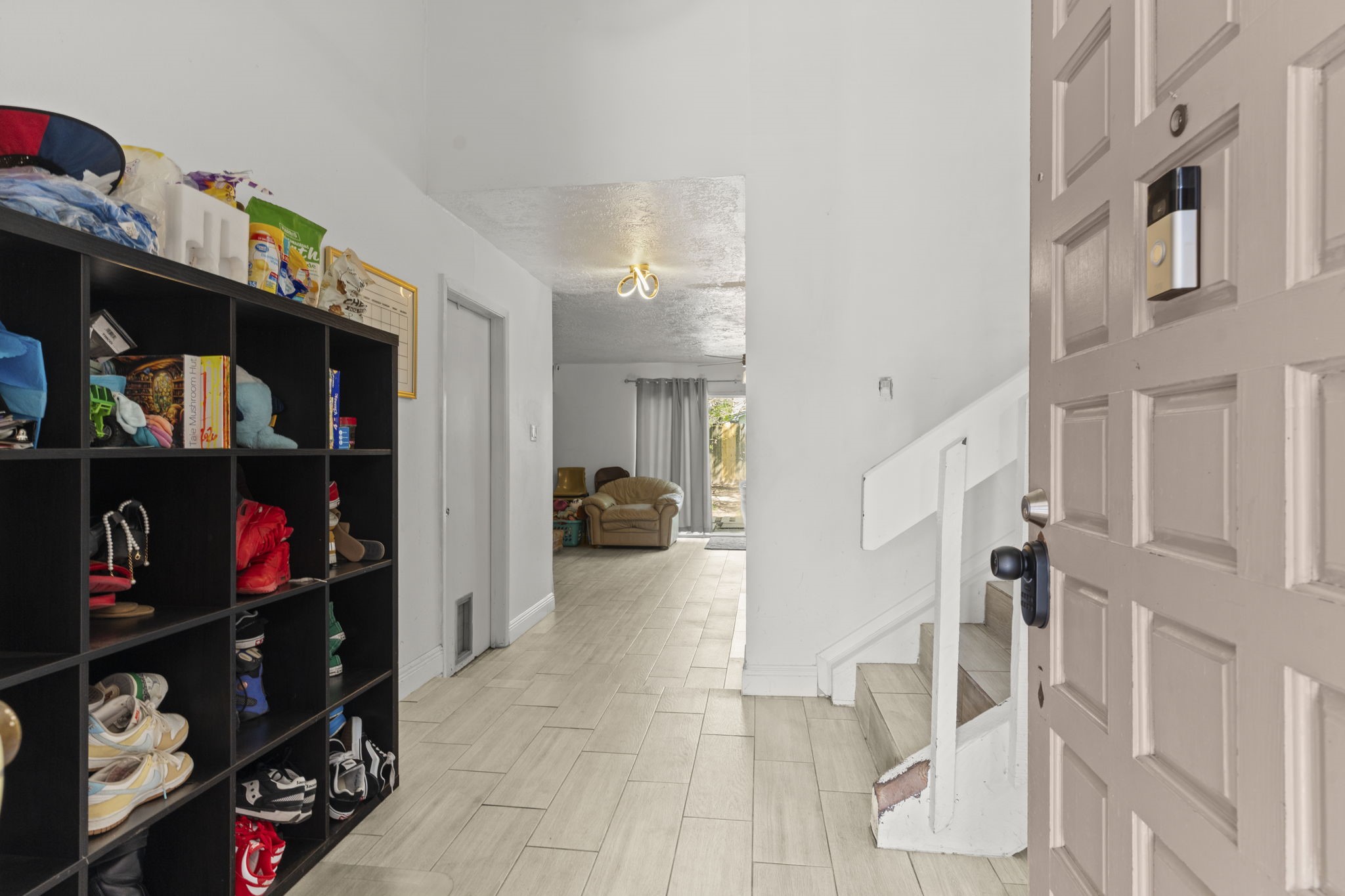 8506 Rivercross Road Houston, TX 77064 - Photo 4 of 32 a living room with furniture a shelf and a fireplace