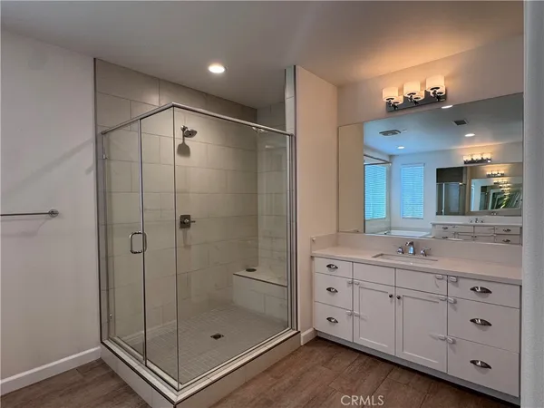 a bathroom with a double vanity sink mirror and shower