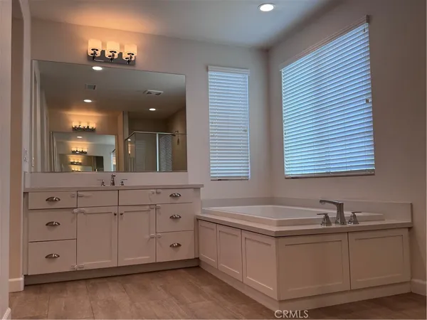 a bathroom with a granite countertop sink mirror and window