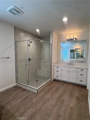 a bathroom with a mirror and a shower