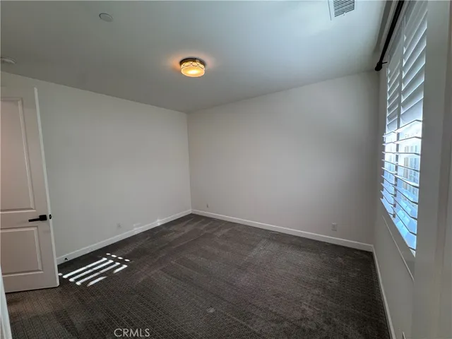 a spacious bathroom with a double vanity sink and a mirror