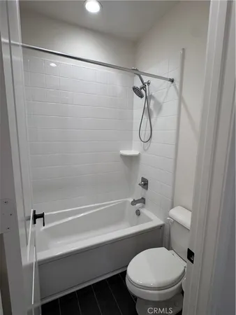 a bathroom with a bath tub with a shower