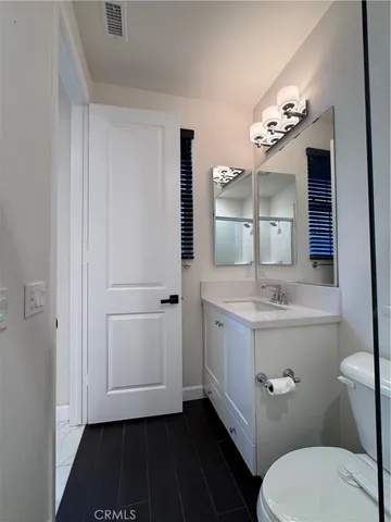 a bathroom with a shower and toilet