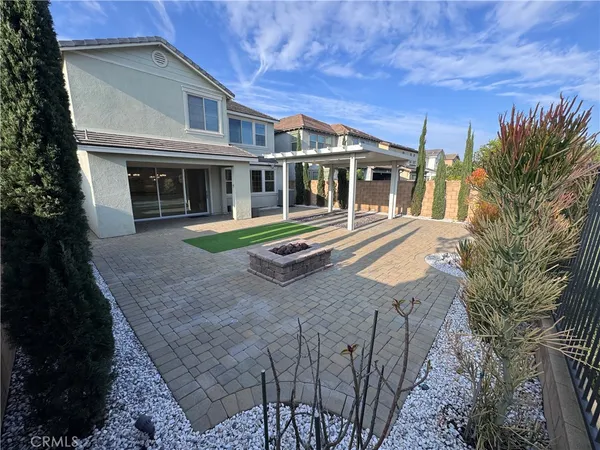 a front view of a house with a yard table and chairs