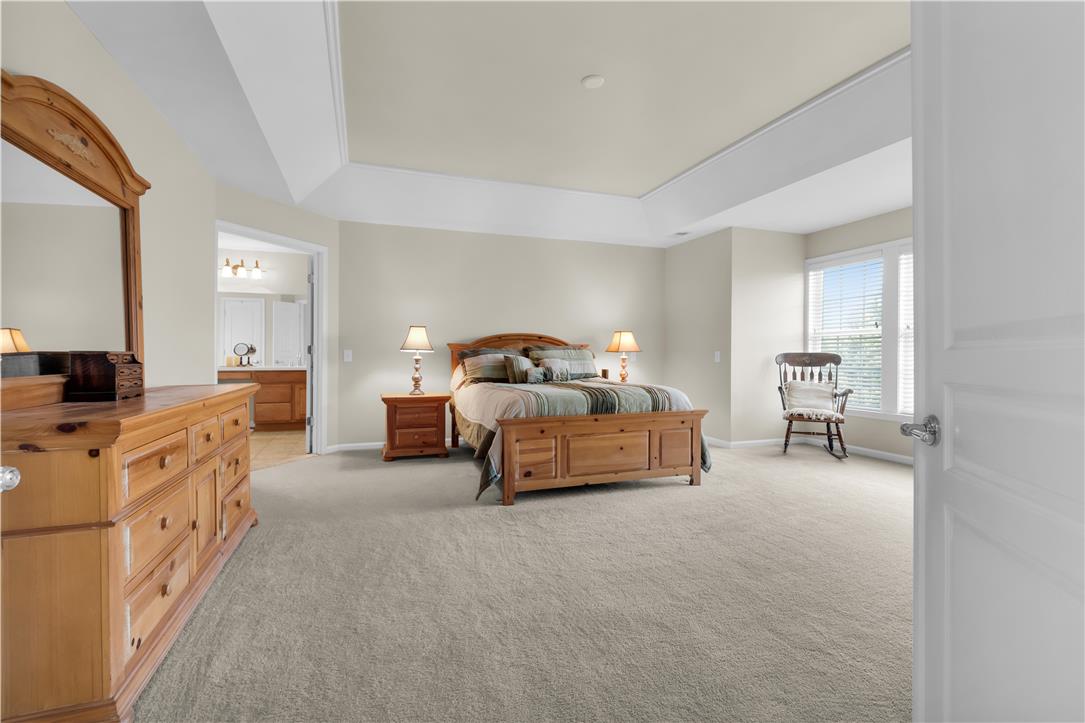 1709 Travers Road Breinigsville, PA 18031 - Photo 28 of 55 A spacious primary bedroom features soft carpet and an en-suite bathroom access.