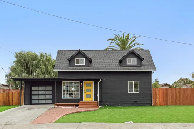 a front view of a house with a yard and garage