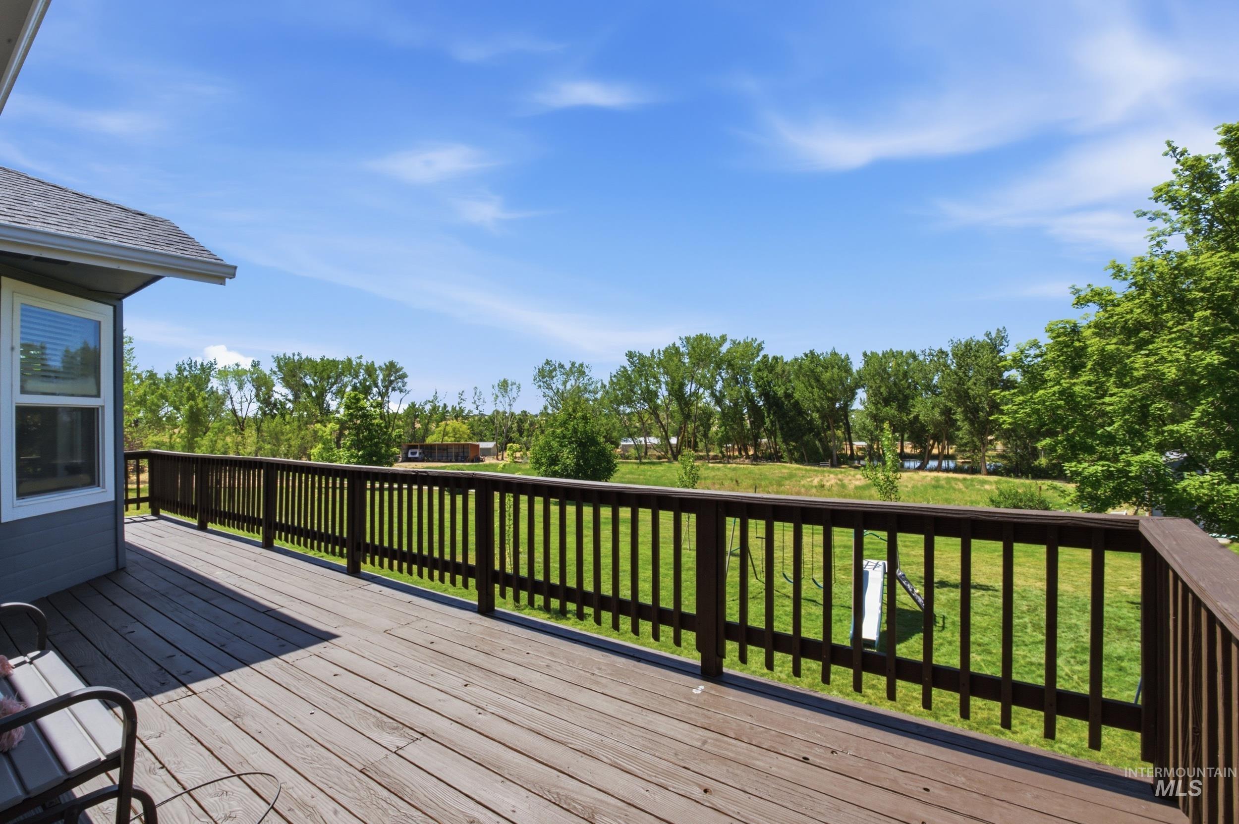 7781 Redmon Road Caldwell, ID 83607 - Photo 18 of 50 Expansive green lawn with scattered trees and a detached shed
