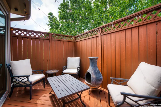 a backyard of a house with table and chairs
