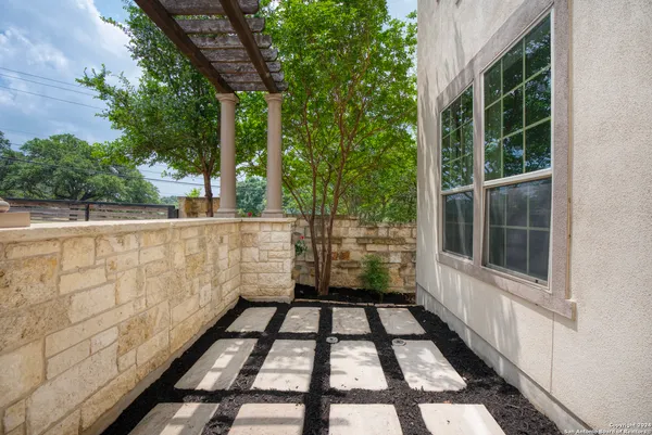 a view of a balcony with wooden floor and plants