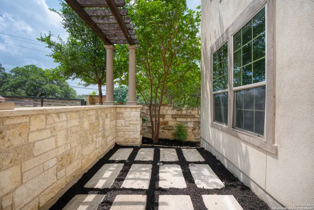 a view of a balcony with wooden floor and plants