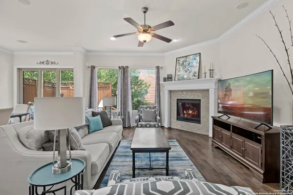 a living room with furniture fireplace and flat screen tv